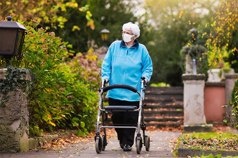 Older woman walking with walker